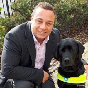 Photograph of Dan Williams with his assistance dog